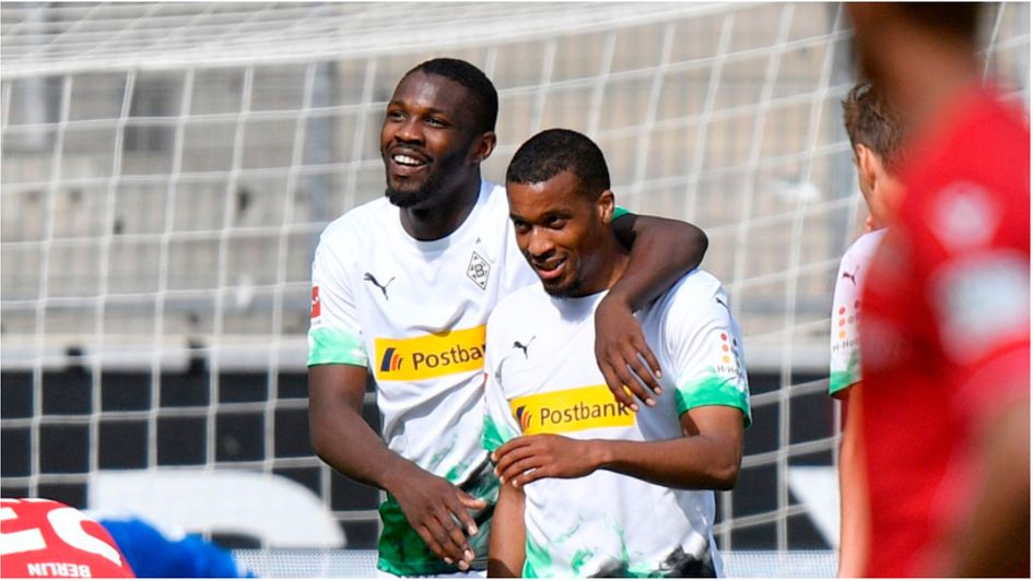 Marcus Thuram (L) and Alassane Plea (R) in action for Borussia Monchengladbach in the Bundesliga