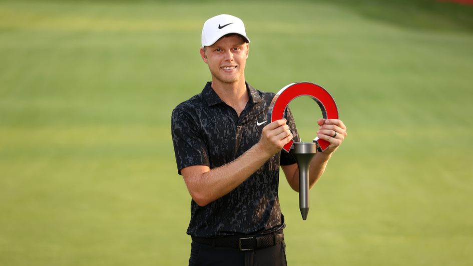 Cam Davis with the trophy after winning the Rocket Mortgage Classic