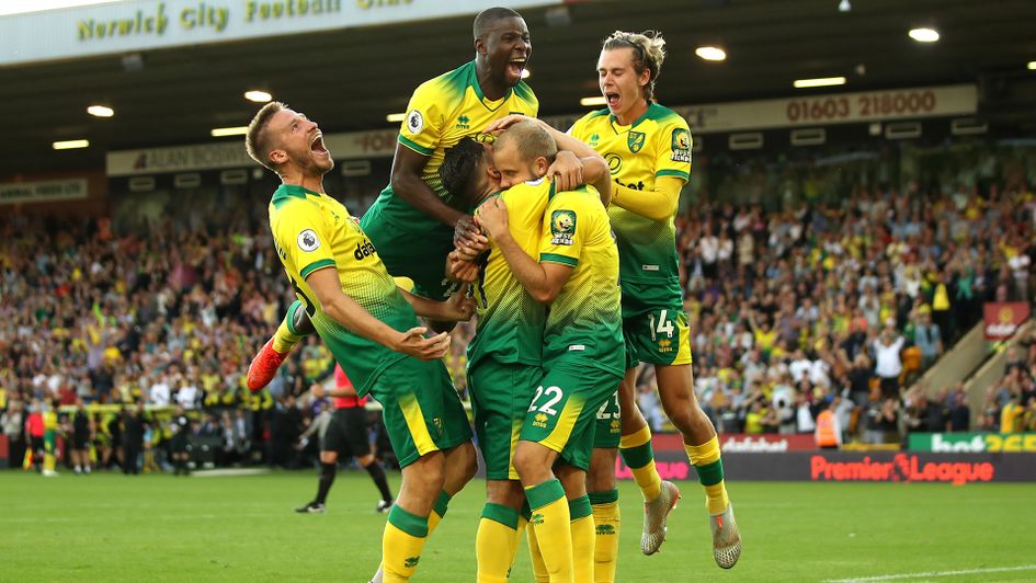 Norwich celebrate scoring their third goal against Manchester City