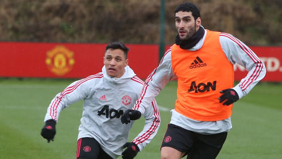 Marouane Fellaini: The Belgian midfielder (right) pictured in training with Alexis Sanchez in January