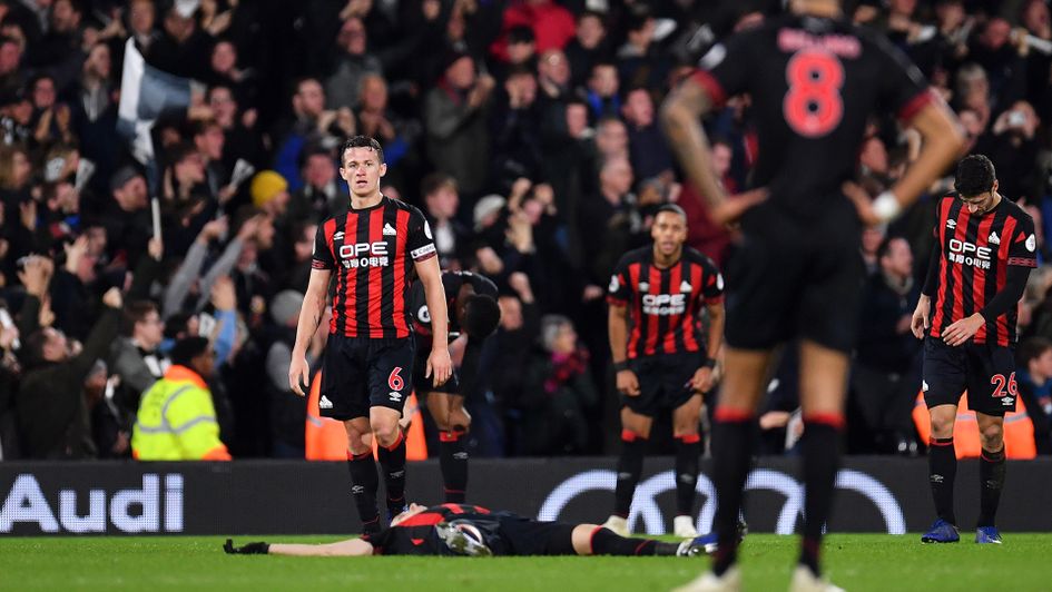 Huddersfield players react after conceding against Fulham