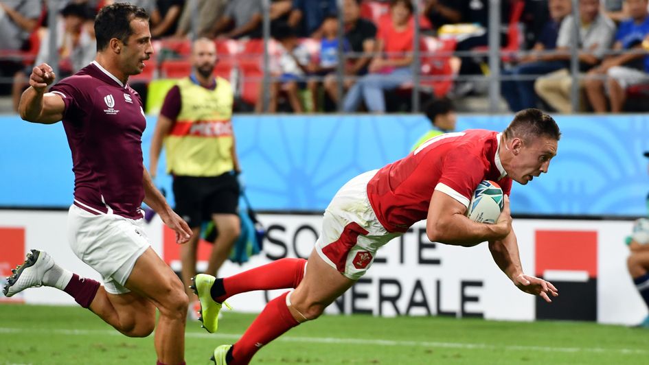 Josh Adams dives over to score for Wales