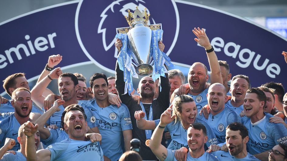 Pep Guardiola lifts the Premier League trophy