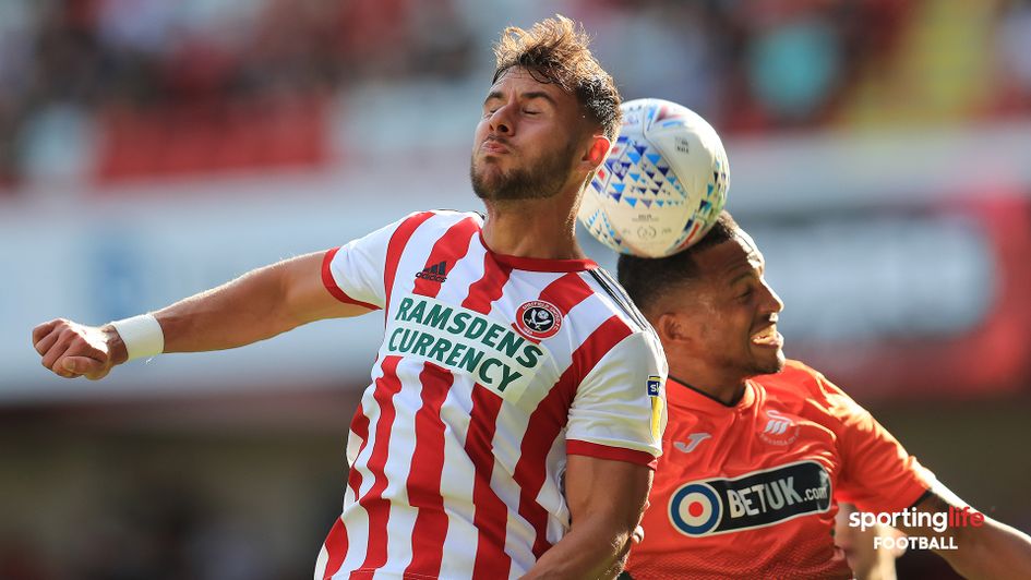 George Baldock battles Martin Olsson for the ball