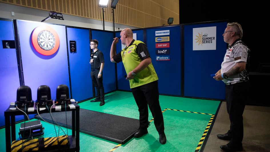 Michael van Gerwen in action against Peter Wright (Picture: Lawrence Lustig)