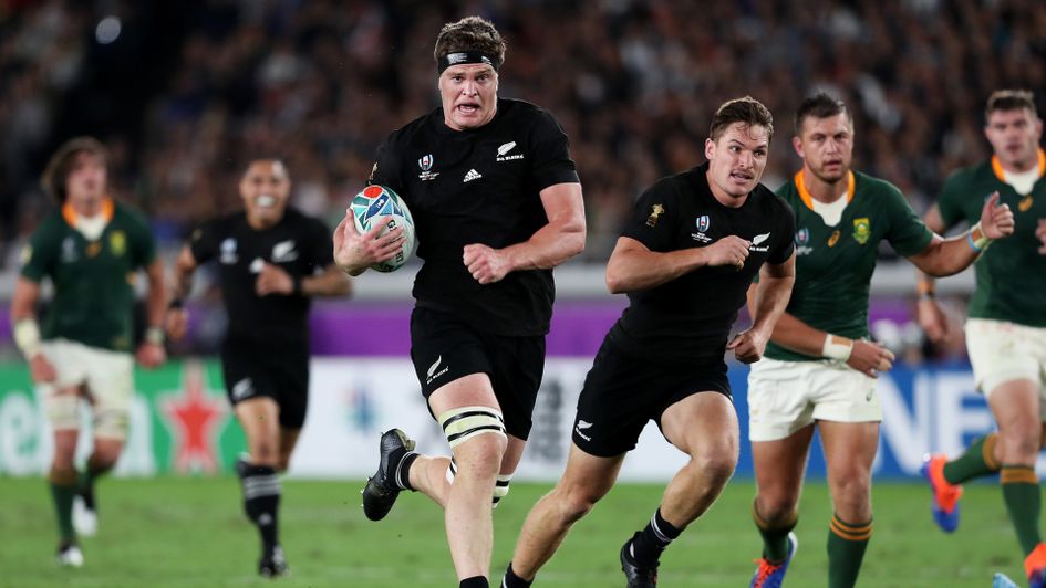 Scott Barrett of New Zealand runs with the ball to score