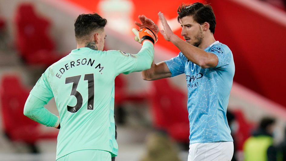 Ederson and Ruben Dias celebrate victory