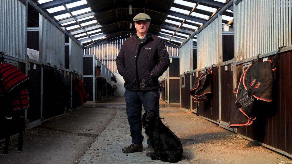 Trainer Colin Tizzard stands with his dog