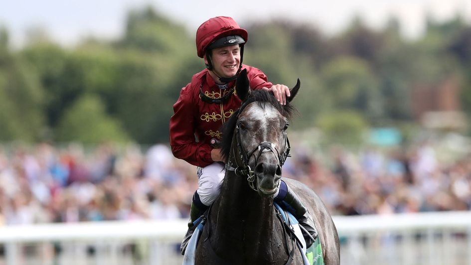 Oisin Murphy celebrates on Roaring Lion after winning the Juddmonte International Stakes