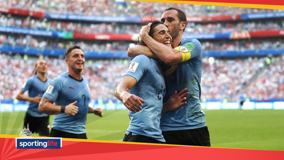 Edinson Cavani celebrates with teammate Diego Godin after scoring Uruguay's third against Russia