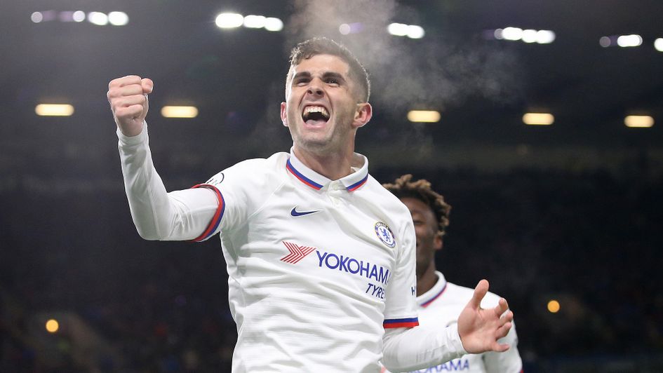 Christian Pulisic celebrates after scoring a hat-trick against Burnley