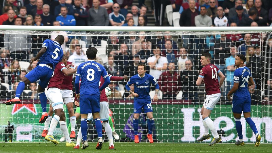 Everton's Kurt Zouma (left) scores at West Ham