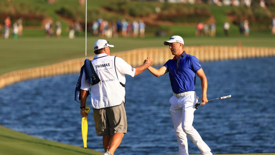 Justin Thomas celebrates with his caddie
