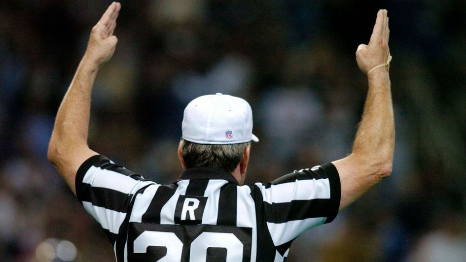 An NFL referee signals a touchdown