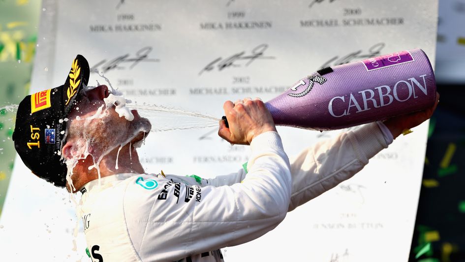 Valtteri Bottas celebrates after taking the chequered flag