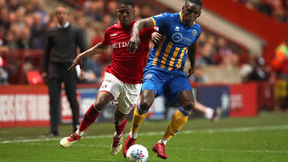 Ezri Konsa and Omar Beckles battle for the ball