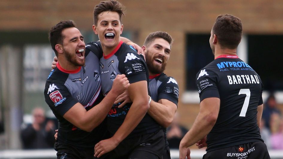 Alex Walker celebrates scoring a try for the Broncos