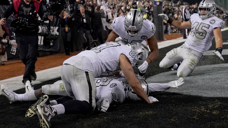 Josh Jacobs celebrates his late touchdown